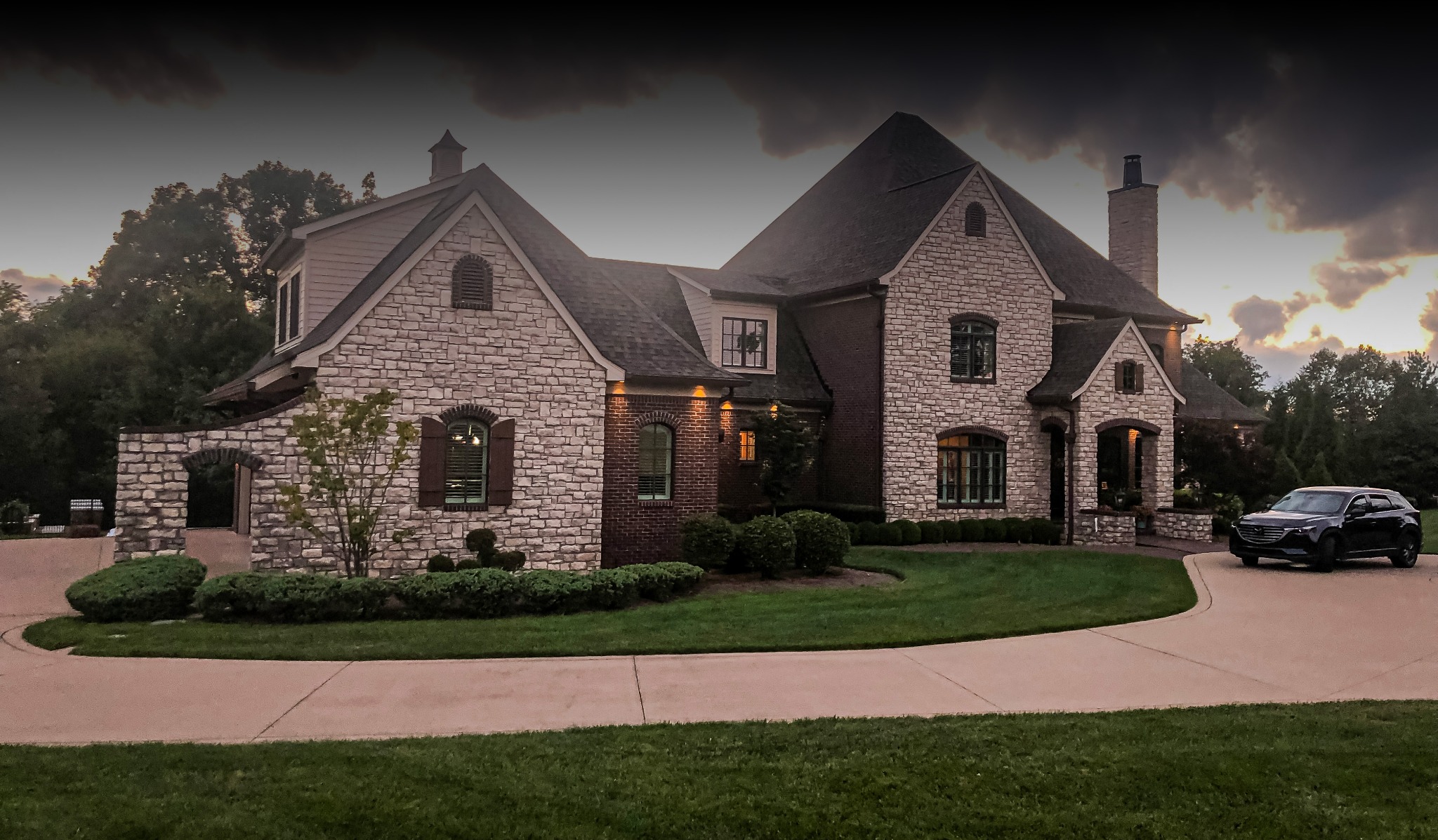 Front view of finished stone and brick residence